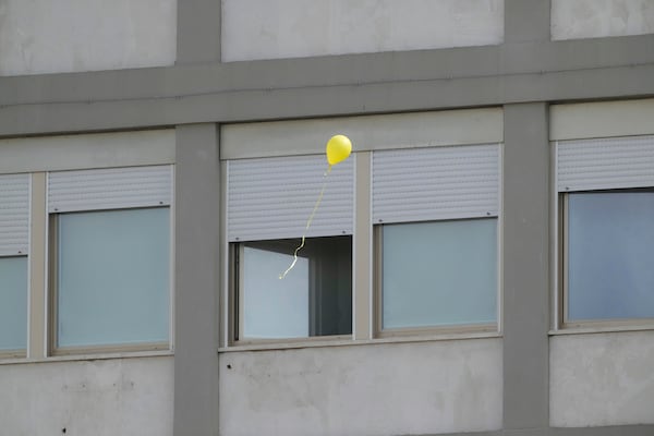 A balloon released by faithful flies near windows of the Agostino Gemelli polyclinic as people gather to pray for Pope Francis in Rome, Sunday, March 16, 2025. (AP Photo/Gregorio Borgia)