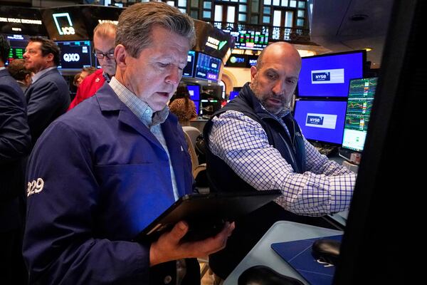 Trader James Matthews, left, and specialist James Denaro work on the floor of the New York Stock Exchange, Friday, May 2, 2025. (AP Photo/Richard Drew)