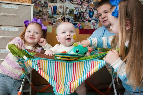 In this photo provided by the Children's Hospital of Philadelphia, KJ Muldoon, center, sits with his siblings after a follow up dose of an experimental gene editing treatment at the hospital in April 2025. (Chloe Dawson/Children's Hospital of Philadelphia via AP)