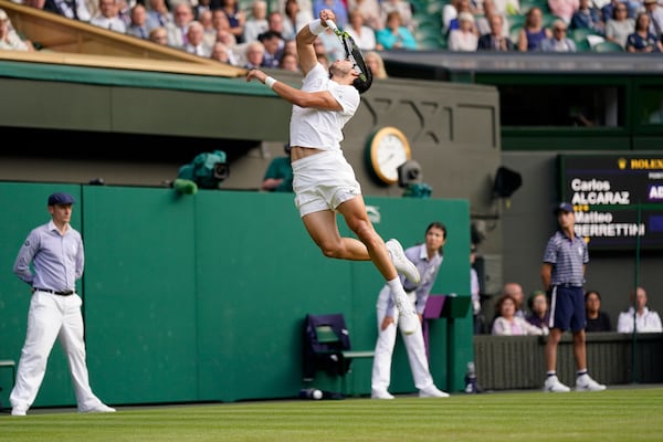 FILE - Spain's Carlos Alcaraz jumps to try and return to Italy's Matteo Berrettini in a men's singles match on day eight of the Wimbledon tennis championships in London, Monday, July 10, 2023. (AP Photo/Alberto Pezzali, File)