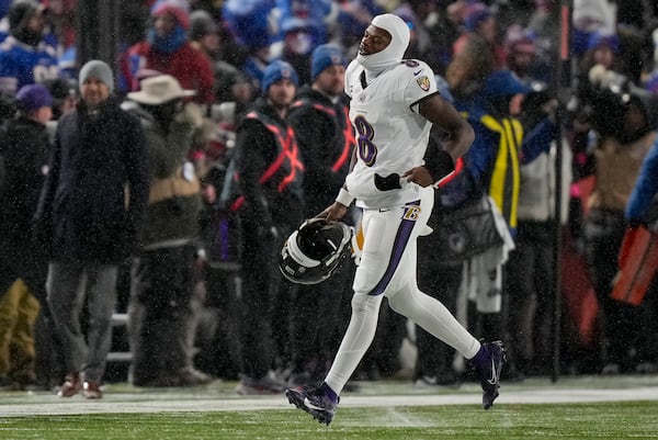 Baltimore Ravens quarterback Lamar Jackson (8) jogs to the sidelines during the fourth quarter of an NFL divisional playoff football game against the Buffalo Bills, Sunday, Jan. 19, 2025, in Orchard Park, N.Y. (AP Photo/Frank Franklin II)