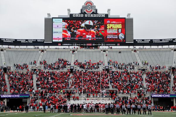 FILE - Ohio State players stand on the field for a moment of silence in honor of Dwayne Haskins, a former Ohio State football player who died last week, during an NCAA college spring football game Saturday, April 16, 2022, in Columbus, Ohio. (AP Photo/Jay LaPrete, File)