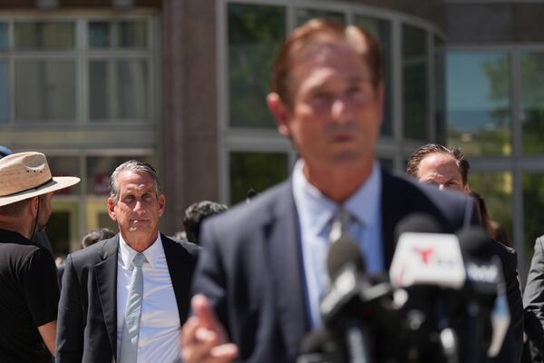 Bryan Freedman, an attorney representing family members of Erik and Lyle Menendez, left, looks on as Los Angeles County District Attorney Nathan Hochman speaks outside of the courthouse Friday, May 9, 2025, in Los Angeles. (AP Photo/Jae C. Hong)