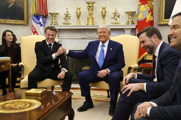 France's President Emmanuel Macron, from second left, speaks with President Donald Trump as Vice President JD Vance and Secretary of State Marco Rubio react during a meeting in the Oval Office of the White House in Washington, Monday, Feb. 24, 2025. (Ludovic Marin/Pool via AP)