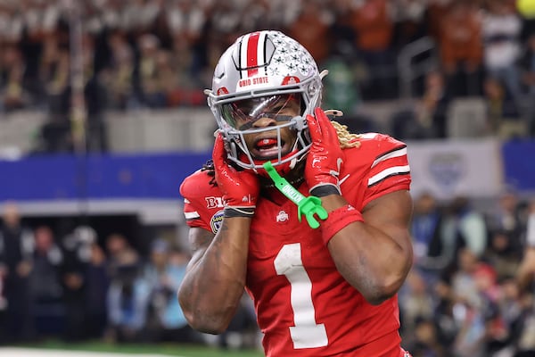 Ohio State running back Quinshon Judkins (1) reacts after scoring a touchdown against Texas during the second half of the Cotton Bowl College Football Playoff semifinal game, Friday, Jan. 10, 2025, in Arlington, Texas. (AP Photo/Gareth Patterson)