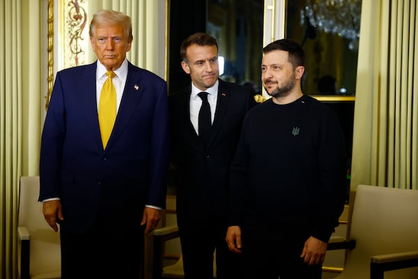 FILE - U.S. President-elect Donald Trump, French President Emmanuel Macron, center, and Ukraine's President Volodymyr Zelenskyy pose before a meeting at the Élysée Palace in Paris, Dec. 7, 2024. (Sarah Meyssonnier/Pool via AP, File)