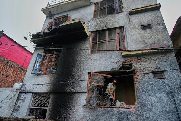 A resident inspects his house damaged by Pakistani artillery shelling in Poonch, along the Line of Control, Indian controlled Kashmir, Thursday, May 8, 2025. (AP Photo/Channi Anand)