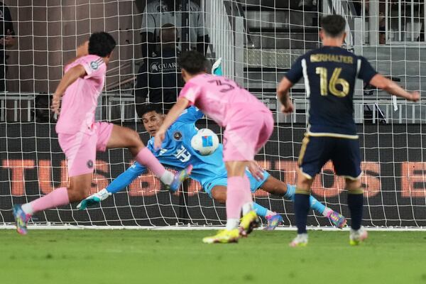 Inter Miami goalkeeper Óscar Ustari, center, can't stop a ball kicked by Vancouver Whitecaps midfielder Sebastian Berhalter (16) for a goal during the second half of a CONCACAF Champions Cup second-leg semifinal soccer match, Wednesday, April 30, 2025, in Fort Lauderdale, Fla. (AP Photo/Lynne Sladky)