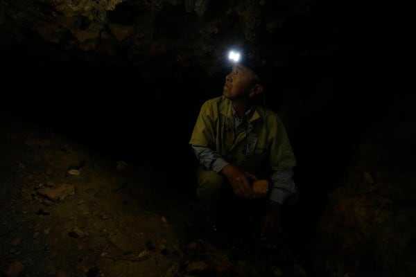 Takamatsu Gushiken, a "gamafuya," an Okinawa dialect meaning a person who digs in a cave, searches in a cave for the remains of those who died during the Battle of Okinawa towards the end of the World War II in 1945, in Itoman, on the main island of the Okinawa archipelago, southern Japan, Saturday, Feb. 15, 2025. (AP Photo/Hiro Komae)