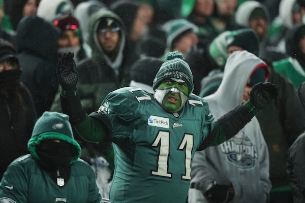 A Philadelphia Eagles' fan cheers during the second half of an NFL football NFC divisional playoff game between the Eagles and the Los Angeles Rams on Sunday, Jan. 19, 2025, in Philadelphia. (AP Photo/Matt Slocum)