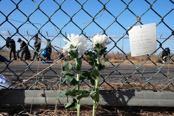 A message of condolences and flowers are seen outside of Muan International Airport in Muan, South Korea, Tuesday, Dec. 31, 2024, following Sunday's plane crash. (AP Photo/Ahn Young-joon)