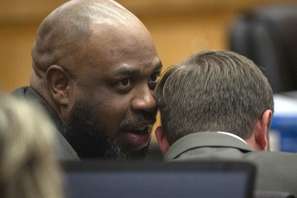 Cleophus Cooksey Jr., left, who is accused of killing eight people over a three-week span in late 2017, talks with attorney Adrian Little during his trial in Maricopa County Superior Court, Monday, May 5, 2025, in Phoenix. (Mark Henle/The Arizona Republic via AP, Pool)
