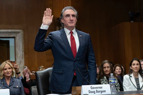 Former Gov. Doug Burgum, President-elect Donald Trump's choice to lead the the Interior Department as Secretary of the Interior, is sworn-in as he testifies before the Senate Energy and Natural Resources Committee on Capitol Hill in Washington, Thursday, Jan. 16, 2025. (AP Photo/Jose Luis Magana)