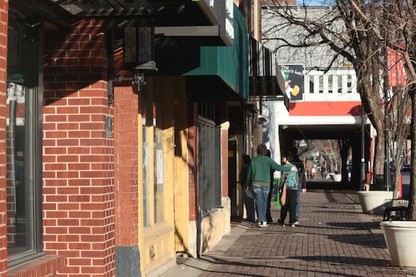 A group of young people enters a shop near the Oldtown district, Friday, Jan. 31, 2025, in downtown Wichita, Kansas. (AP Photo/John Hanna)