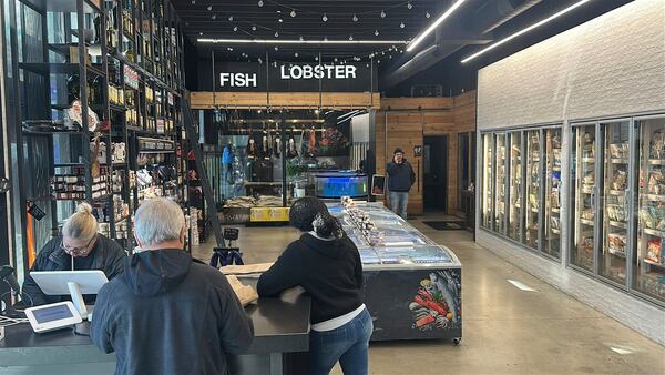 Shoppers check out at an Ocean Seafood Depot store Friday, Jan. 24, 2025, in Newark, N.J. (AP Photo/Ted Shaffrey)