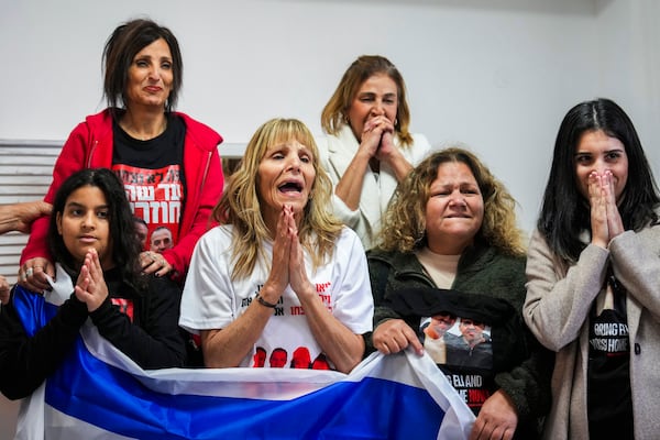 Family of Israeli hostage Eli Sharabi, whose wife and two daughters were killed on Oct. 7 attack, react as they wait the live broadcast of him being released from Hamas captivity in Gaza, in Tel Aviv, Israel, Saturday, Feb. 8, 2025, as part of the Israel-Hamas ceasefire deal. (AP Photo/Ariel Schalit)