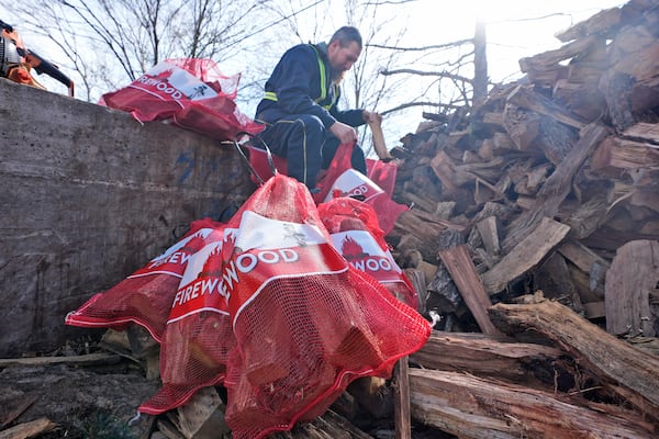 Phillip Stanford prepares firewood for sale ahead of a winter storm expected to hit the North Texas region later tomorrow Wednesday, Jan. 8, 2025, in Dallas. (AP Photo/LM Otero)