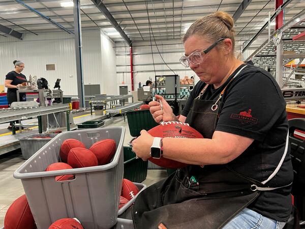 Wilson Sporting Goods football factory employee Nicole Rainsburg inspects the Super Bowl game balls before they are ready to be shipped Monday, January 27, 2025, in Ada, Ohio. (AP Photo/Patrick Aftoora-Orsagos)