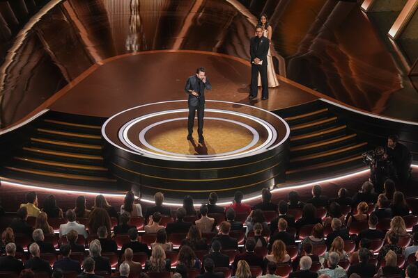 Kieran Culkin accepts the award for best performance by an actor in a supporting role for "A Real Pain" during the Oscars on Sunday, March 2, 2025, at the Dolby Theatre in Los Angeles. Robert Downey Jr. looks on from right.(AP Photo/Chris Pizzello)