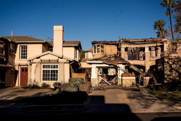 FILE - A home destroyed by the Eaton Fire, right, stands next a home that survived in Altadena. Calif., on Monday, Jan. 13, 2025. (AP Photo/Noah Berger, File)