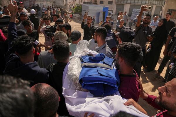 The body of Palestinian journalist Yahya Sobeih, who was killed along with at least 28 others in an Israeli army strike on a restaurant, is carried for burial at Shifa hospital in Gaza City, Wednesday, May 7, 2025. (AP Photo/Jehad Alshrafi)