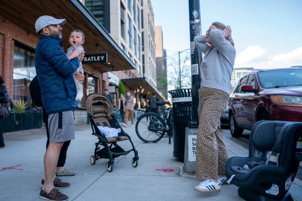 Elizabeth Mahon, owner of the baby store Three Littles, prepared to install a new car seat for a customer who made the purchase ahead of tarriff-driven price increases, at the Union Market location in Washington, on Wednesday, April 16, 2025. (AP Photo/Nathan Howard)