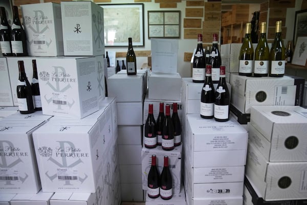 Boxes of wine are for sale at a wine dealer shop as President Donald Trump threatened a 200% tariff on European wine, Champagne and spirits if the European Union goes forward with a planned tariff on American whiskey, Thursday, March 13, 2025 in Ville d'Avray, outside Paris. (AP Photo/Christophe Ena)