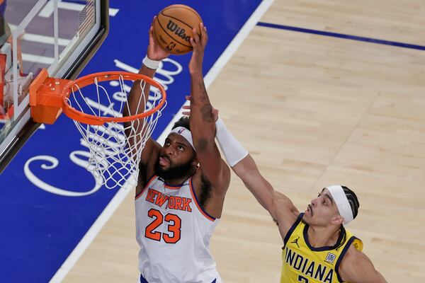 New York Knicks center Mitchell Robinson (23) goes up for a shot against Indiana Pacers guard Andrew Nembhard (2) during the fourth quarter of Game 2 of the NBA basketball Eastern Conference final, Friday, May 23, 2025, in New York. (AP Photo/Adam Hunger)