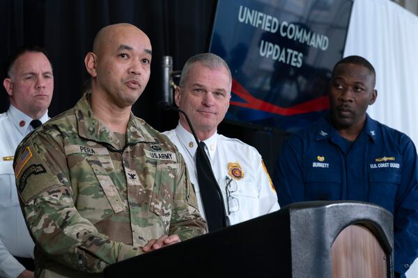 Col. Francis Pera, commander of the U.S. Army Corps of Engineers, from left, speaks as D.C. Fire and EMS Chief John Donnelly and U.S. Coast Guard Captain Patrick Burkett listen during a news conference at Ronald Reagan Washington National Airport, Sunday, Feb. 2, 2025, in Arlington, Va. (AP Photo/Jose Luis Magana)