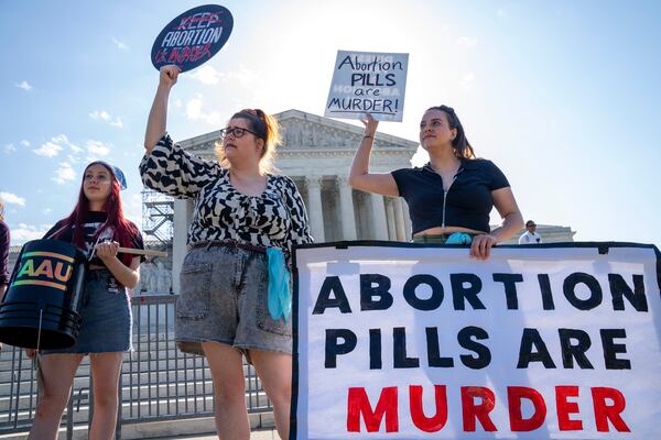 FILE - Staff with the group, Progressive Anti-Abortion Uprising, Kristin Turner, of San Francisco, left, Lauren Handy, of Washington, and Caroline Smith, of Washington, right, demonstrate against abortion pills outside of the Supreme Court, Friday, April 21, 2023, ahead of an abortion pill announcement by the court in Washington. (AP Photo/Jacquelyn Martin, File)