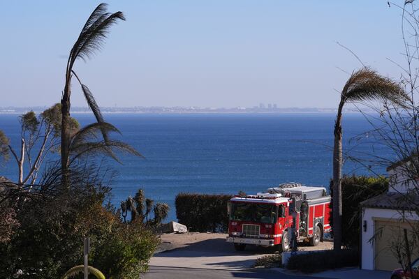 A firetruck drives up a road in Malibu, Calif., Sunday, Jan. 12, 2025. (AP Photo/Mark J. Terrill)