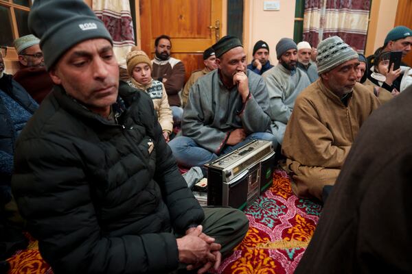 Kashmiri men listen Sufi songs on a tape recorder during a Sufi gathering in the outskirts of Srinagar, Indian controlled Kashmir, Thursday, Feb. 13, 2025. (AP Photo/Dar Yasin)