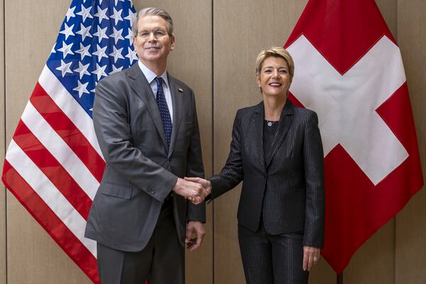 US Secretary of the Treasury Scott Bessent, left, shakes hands with Switzerland's President Karin Keller-Sutter, right, during a bilateral meeting between Switzerland and the United States, in Geneva, Switzerland, on Friday, May 9, 2025. (Martial Trezzini/Keystone via AP)