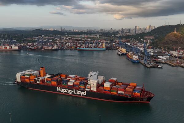 A cargo ship sails past the Panama Canal's Port of Balboa, managed by CK Hutchison Holdings, in Panama City, Thursday, March 13, 2025. (AP Photo/Matias Delacroix)