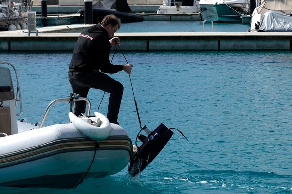 A personal takes out from the seawater an underwater drone during a demonstration at a Marina in southern resort of Ayia Napa, Cyprus, Monday, Feb. 24, 2025. (AP Photo/Petros Karadjias)