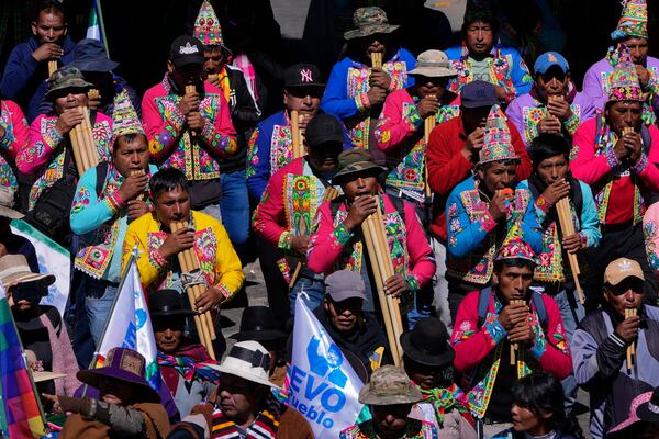 Quechua musicians play flutes in support of former President Evo Morales during a march to the Electoral Tribunal offices in El Alto, Bolivia, Friday, May 16, 2025. (AP Photo/Juan Karita)