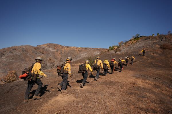 Fire crews work the burn zone of the Palisades Fire in Mandeville Canyon Thursday, Jan. 16, 2025, in Los Angeles. (AP Photo/Jae C. Hong)