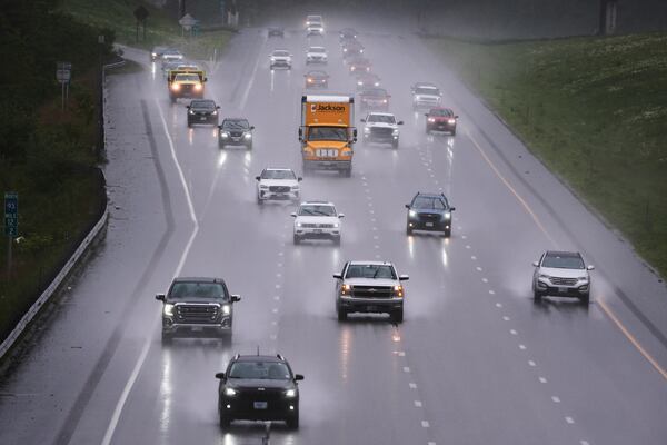 As rain from a nor'easter falls on the pavement, vehicles roll north on Route 93 during the start of the Memorial Day holiday travel, Thursday, May 22, 2025, in Londonderry, N.H. (AP Photo/Charles Krupa)