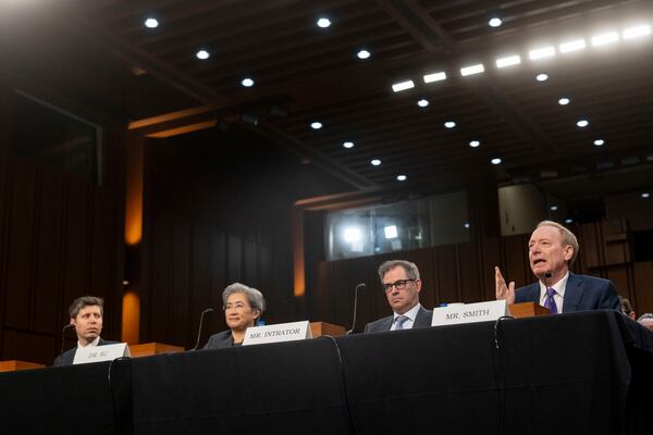 Brad Smith, Vice Chair and President, Microsoft Corporation, right, testifies before a Senate Committee on Commerce, Science, and Transportation hearing with, from left, Sam Altman, Co-Founder and Chief Executive Officer, OpenAI, Dr. Lisa Su, Chief Executive Officer and Chair, Advanced Micro Devices (AMD) and Michael Intrator, Co-Founder and Chief Executive Officer, CoreWeave, Thursday, May 8, 2025, in Washington. (AP Photo/Kevin Wolf)