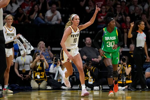 Indiana Fever guard Lexie Hull (10) celebrates after making a 3-point basket during the first half of an exhibition women's basketball game against Brazil, Sunday, May 4, 2025, in Iowa City, Iowa. (AP Photo/Charlie Neibergall)