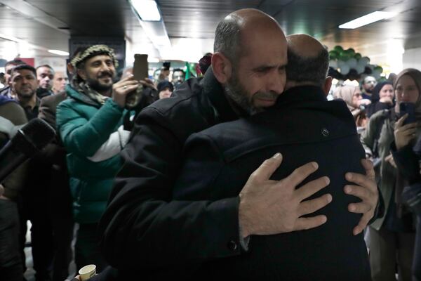 A Syrian man hugs a relative at the arrival terminal, after a first international commercial flight since the fall of former Syrian President Bashar Assad landed at Damascus international airport, in Damascus, Syria, Tuesday, Jan. 7, 2025. (AP Photo/Omar Sanadiki)