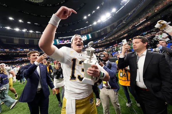 Notre Dame quarterback Riley Leonard (13) celebrates after a quarterfinal game against Georgia in a College Football Playoff, Thursday, Jan. 2, 2025, in New Orleans. (AP Photo/Gerald Herbert)