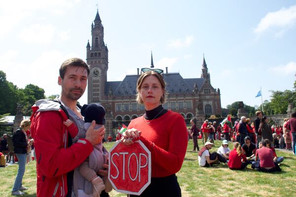Roos Lingbeek, right, husband Stijn Joosten and daughter Dido stand in front of the Peace Palace during the Red Line protest in The Hague, Netherlands on Sunday, May 18, 2025. (Niels van der Pas via AP)