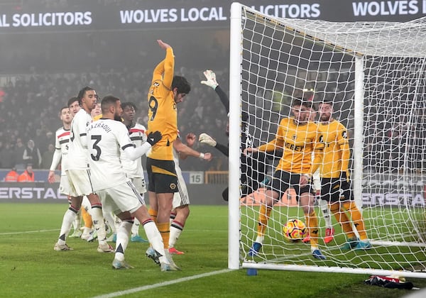 Wolverhampton Wanderers' Matheus Cunha, not in the picture, scores the opening goal during the English Premier League soccer match between Wolverhampton Wanderers and Manchester United at the Molineux Stadium, Wolverhampton, England, Thursday, Dec. 26, 2024. (David Davies/PA via AP)