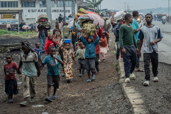 People displaced by the fighting with M23 rebels make their way to the center of Goma, Democratic Republic of the Congo, Sunday, Jan. 26, 2025. (AP Photo/Moses Sawasawa)