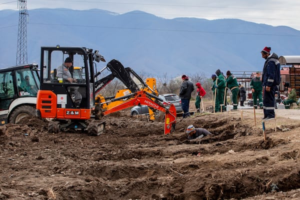 Workers dig graves for the victims of a massive nightclub fire in the town of Kocani, North Macedonia, Tuesday, March 18, 2025. (AP Photo/Visar Kryeziu)