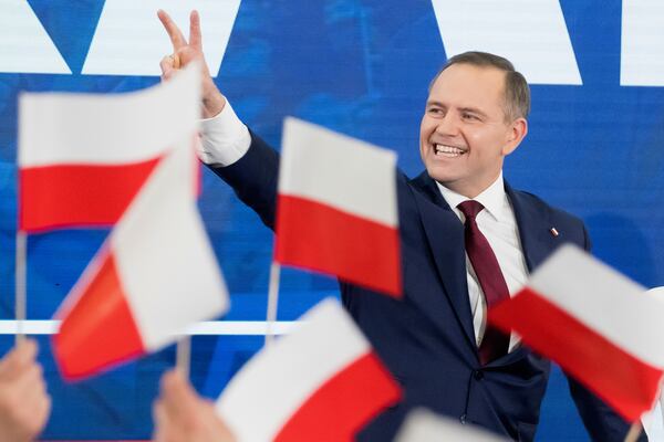 Karol Nawrocki, presidential candidate for the 2025 Polish presidential election supported by Poland's national conservative Law and Justice party, waves to supporters as first exit polls following presidential elections are announced in Gdansk, Poland, Sunday, May 18, 2025. (AP Photo/Wojciech Strozyk)