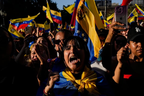 Opponents of Venezuelan President Nicolas Maduro participate in a protest the day before his inauguration for a third term, in Santiago, Chile, Thursday, Jan. 9, 2025. (AP Photo/Esteban Felix)