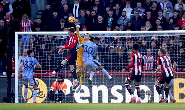 Tottenham Hotspur goalkeeper Antonin Kinsky punches the ball clear during the English Premier League soccer match between Brentford and Tottenham Hotspur at the Gtech Community Stadium, London, Sunday Feb. 2, 2025. (Steven Paston/PA via AP)