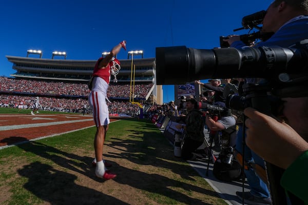 Oklahoma wide receiver Zion Kearney celebrates in front of photographers after scoring a touchdown on a pass from quarterback Michael Hawkins Jr. during the first half of the Armed Forces Bowl NCAA college football game against Navy, Friday, Dec. 27, 2024, in Fort Worth, Texas. (AP Photo/Julio Cortez)